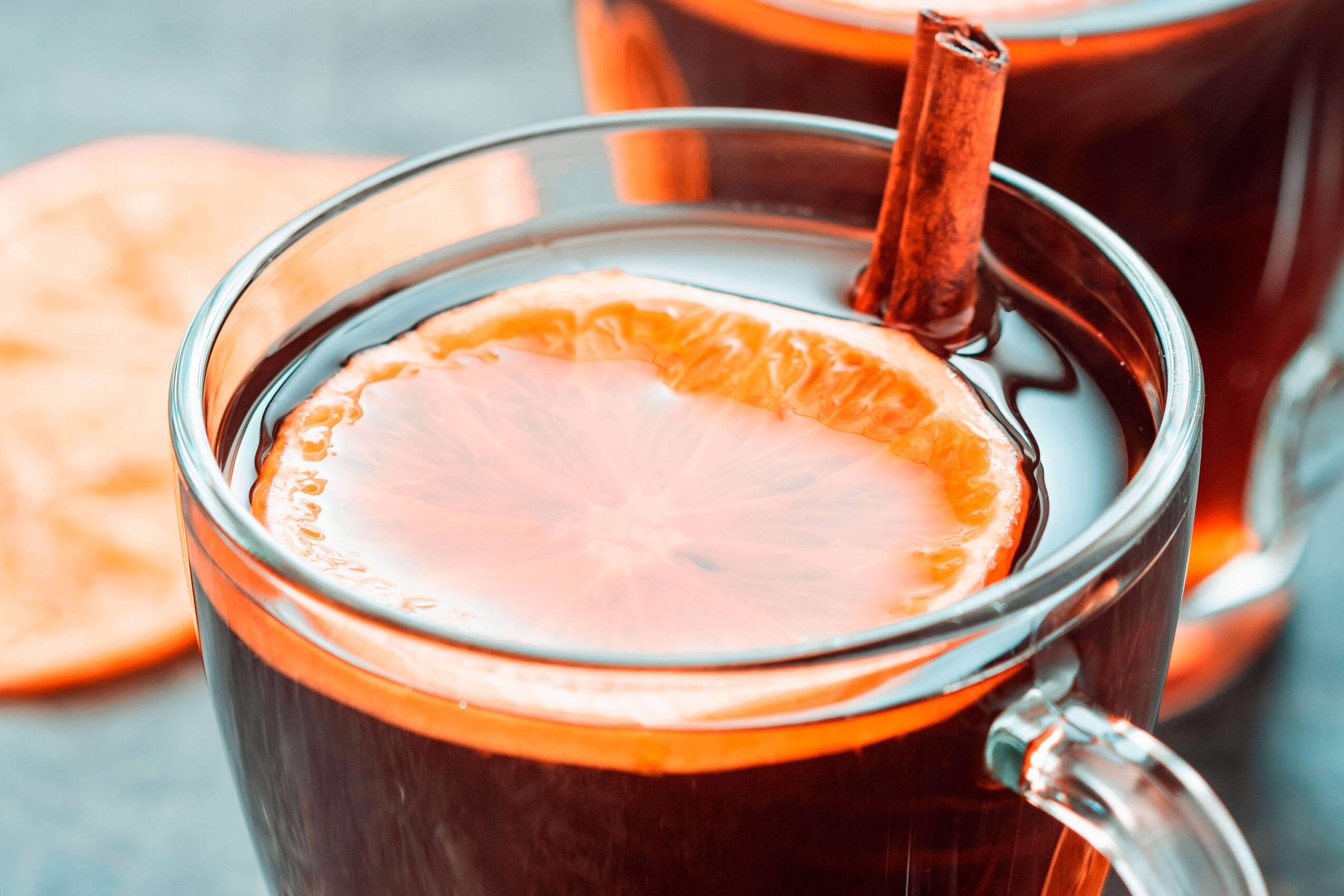 Christmas traditional hot beverage mulled wine with spices orange slices glass cups table